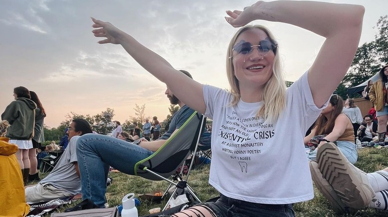 Woman wearing t-shirt, lavender sunglasses
