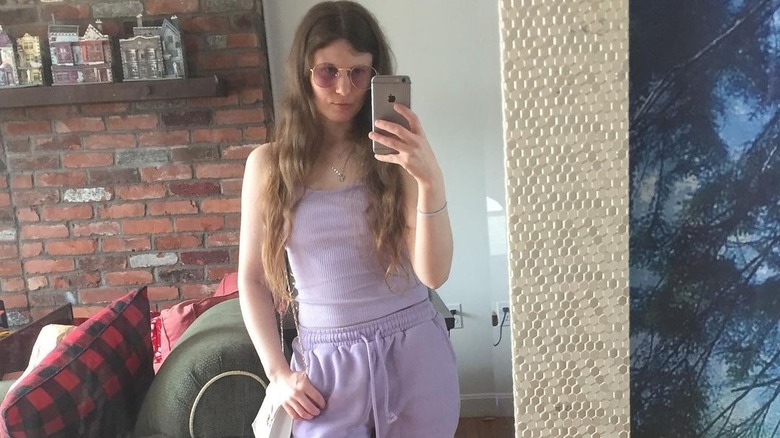 Girl wearing lavender outfit, sunglasses