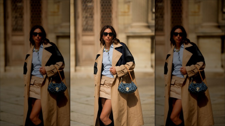 woman wearing leather-accent trenchcoat