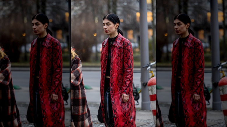 woman wearing snake print trenchcoat