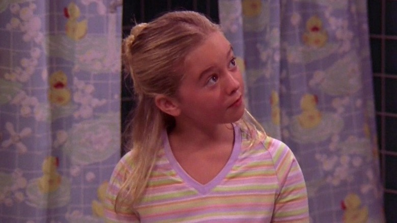 Madylin Sweeten posing in a multi-colored T-shirt on 