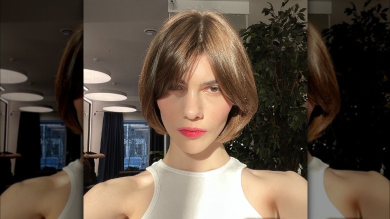 Girl with a curtain style lop cut.