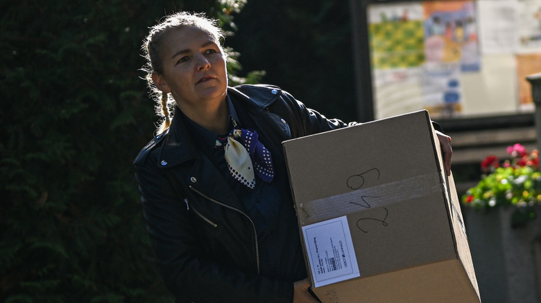 woman carrying a box