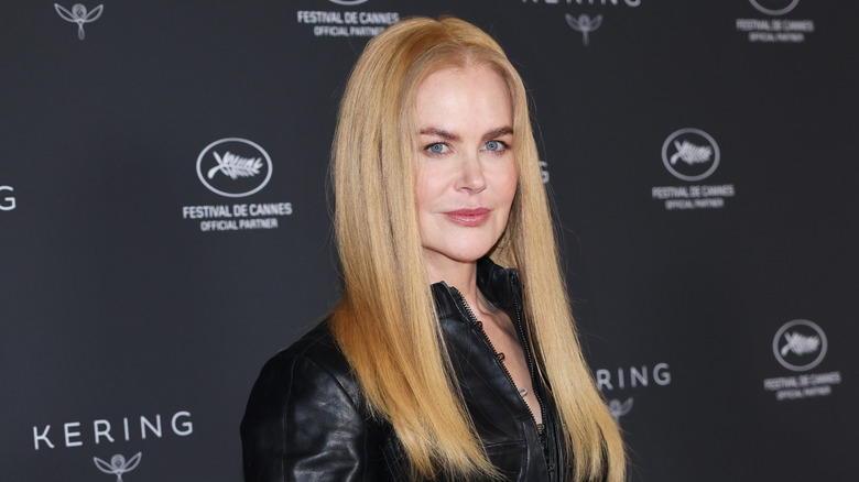 Nicole Kidman poses for photos on a red carpet with long blond hair