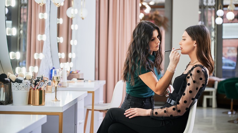 Woman having makeup applied