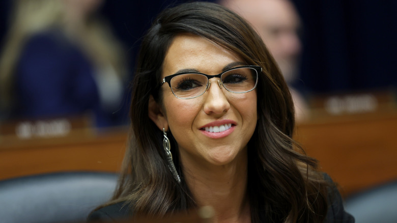 Lauren Boebert with pink lipstick and glasses wearing her hair down