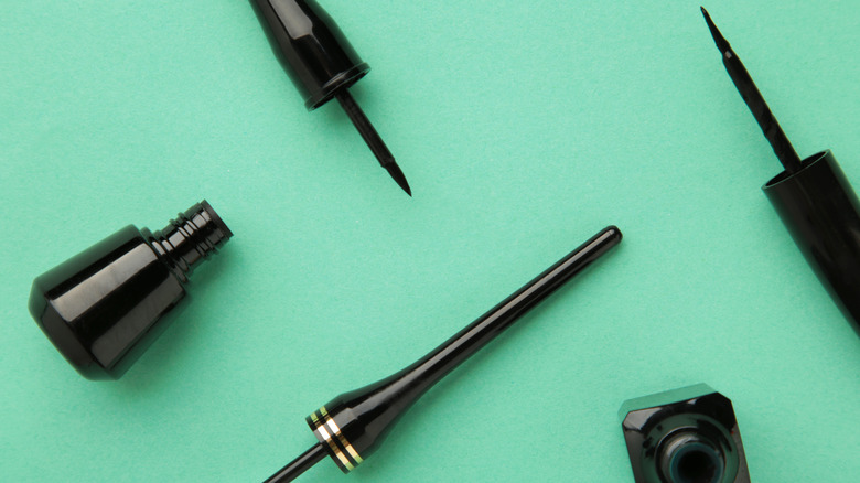 eyeliners on mint green background