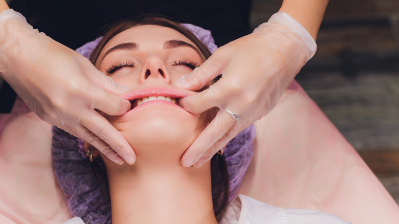 Woman receives buccal massage