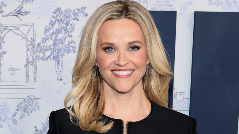Reese Witherspoon smiling in a black outfit