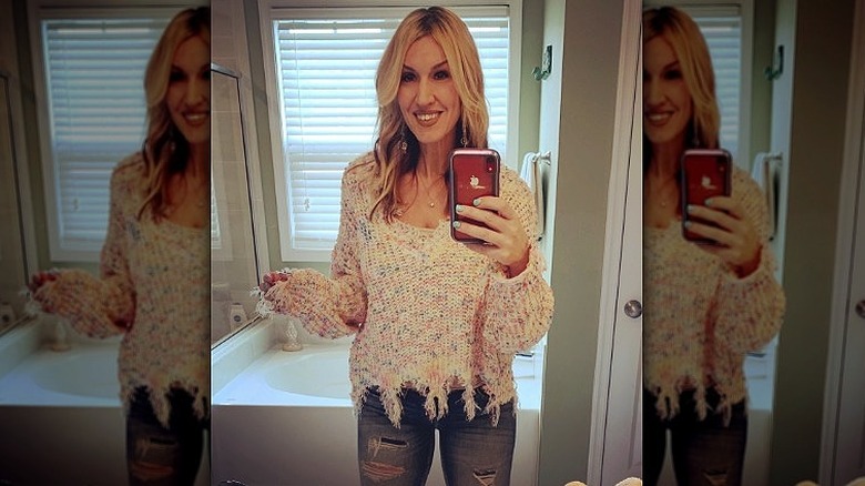 woman taking distressed outfit mirror selfie