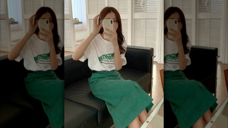 Woman in green corduroy midi skirt