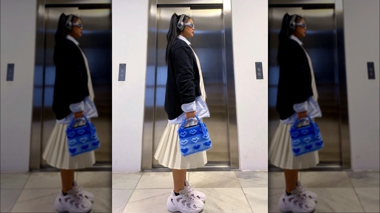 Woman in pleated midi skirt