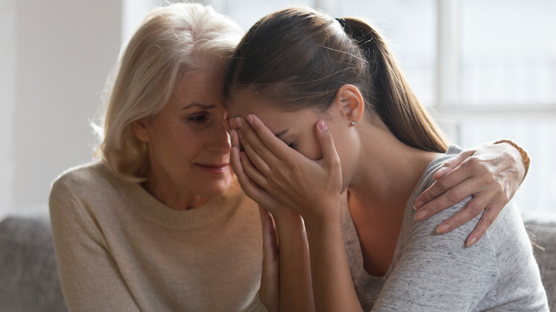 Woman talking to older woman