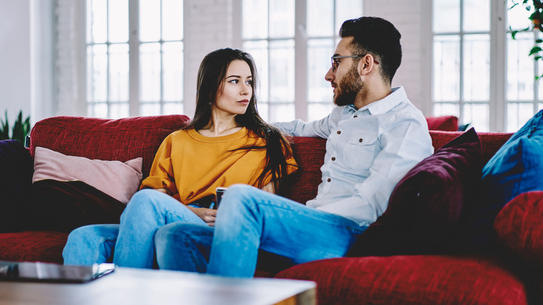 Couple sitting, having serious talk