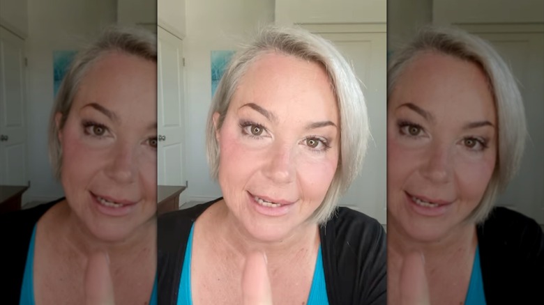 Kim Rhodes filming a video and talking to the camera