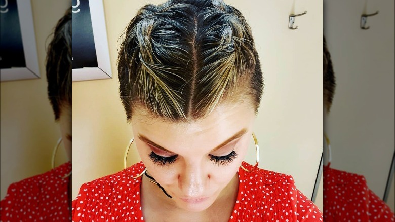 A woman with short braided hair