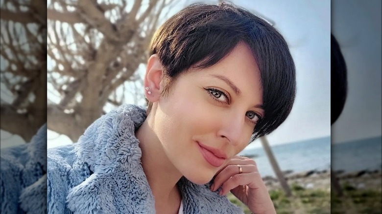 A woman with short hair and side bangs