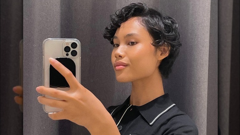 A woman with short curly hair