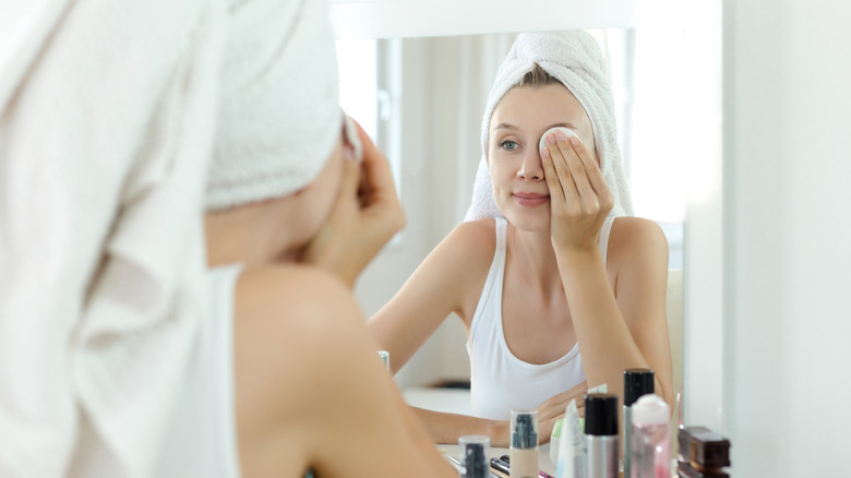 Woman removing eye makeup