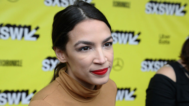 Alexandria Ocasio-Cortez speaking in a turtleneck