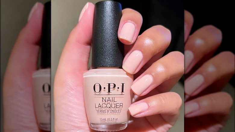 Hand holding OPI Bubble Bath bottle