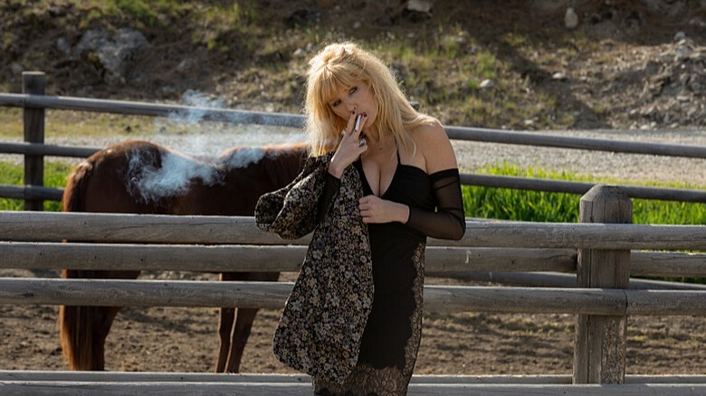 Beth Dutton smokes in the horse arena on Yellowstone