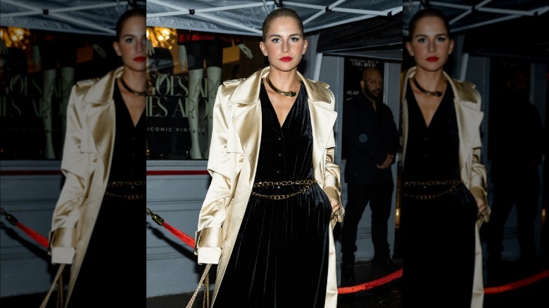 woman wearing velvet jumpsuit with chain link belt