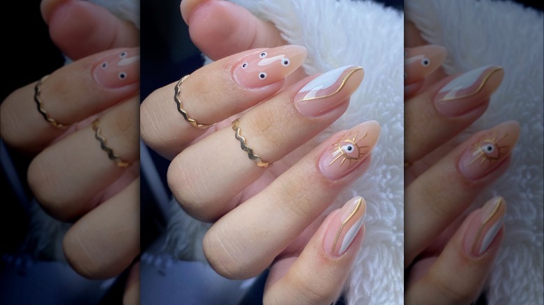 Evil eye themed almond nails with finger rings