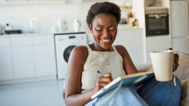 Woman writing in notebook 