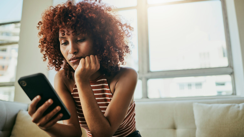 woman looking at smartphone