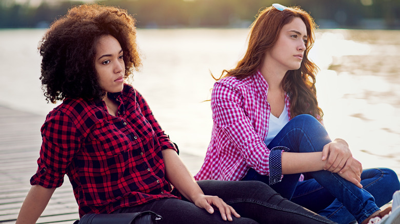 tense friends sitting outside