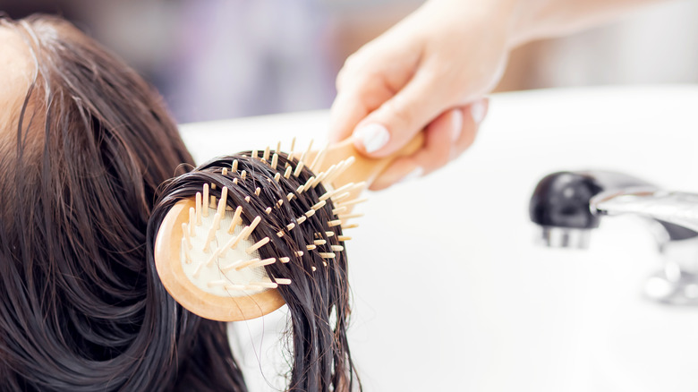 woman with a brush through her hair 