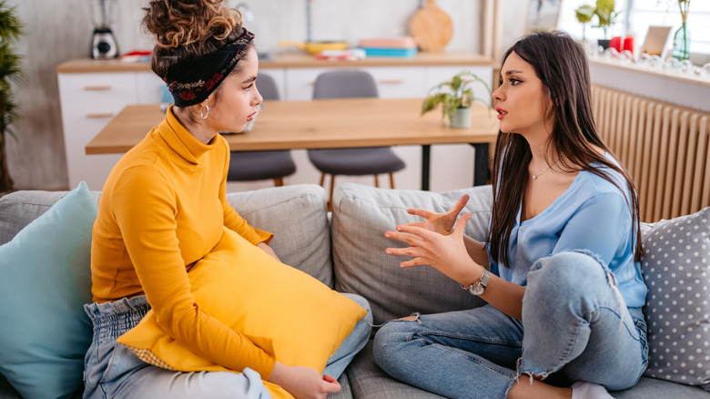 Two friends talking on sofa