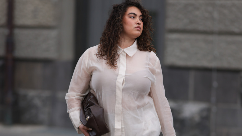 Woman wearing a sheer white blouse