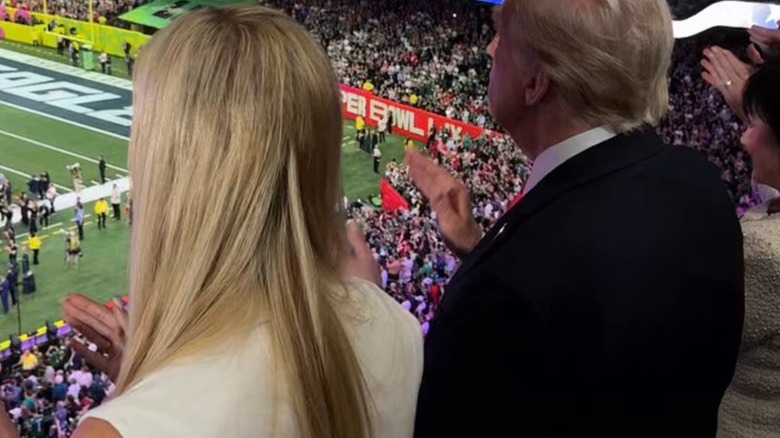 Ivanka Trump clapping at the 2025 Super Bowl with her hair extensions showing.