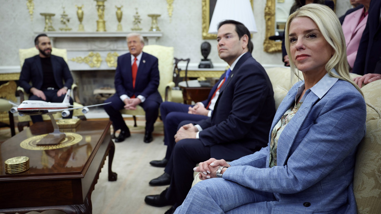 Pam Bondi wearing an outdated periwinkle suit with an unmatched blouse