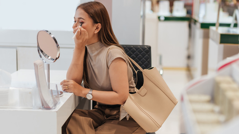 Woman applying eyeliner