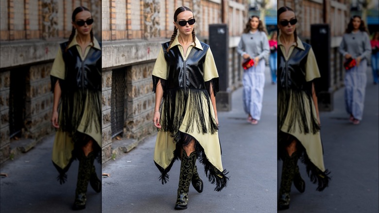 Woman wearing fringed vest over shirt dress