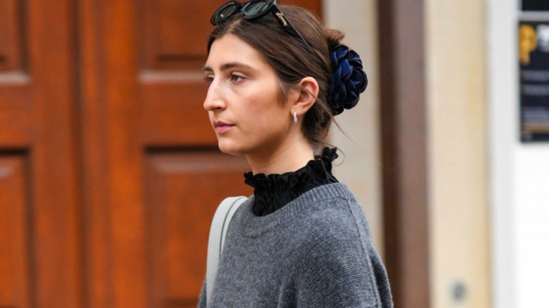 Woman wearing black turtleneck under sweater