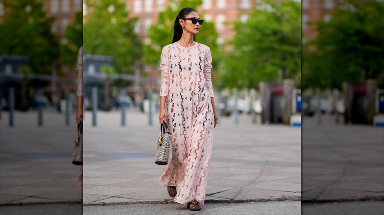 woman walking with a white maxi dress and mesh ballet flats