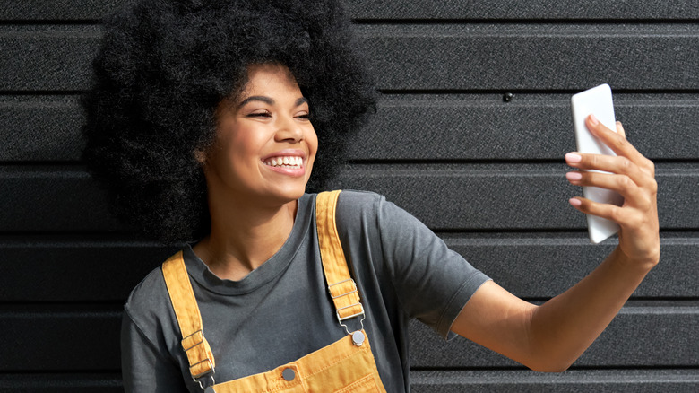 Smiling girl taking selfie
