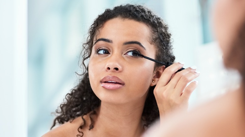 woman applying mascara
