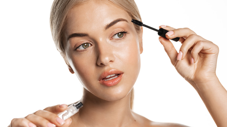 woman applying lash product