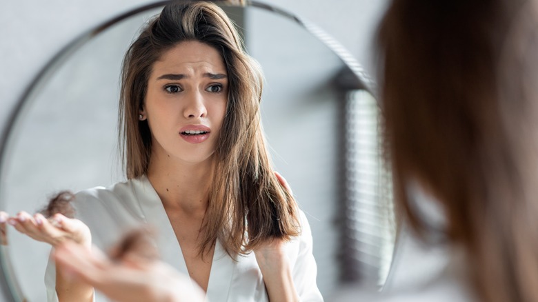 Woman questions self in mirror