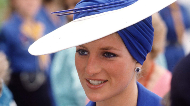 Princess Diana wearing blue eyeliner and a hat in the late 1980s