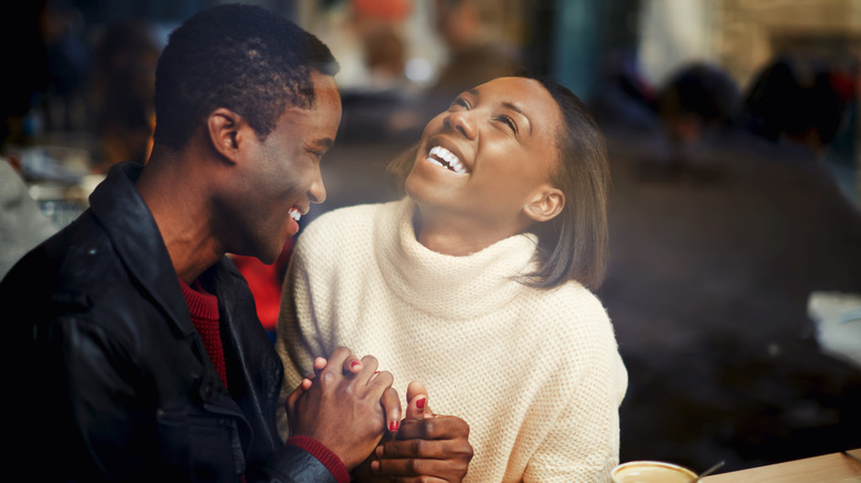 couple holding hands and smiling