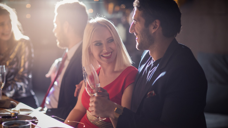 A couple sitting at a table with friends
