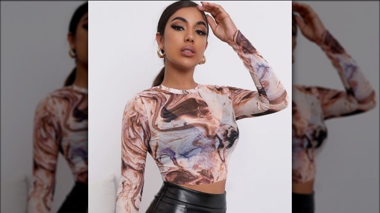 Woman wearing marble mesh top