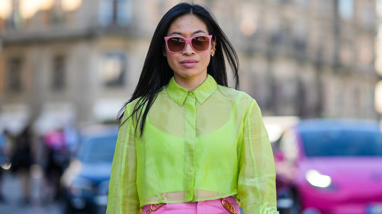 Woman wears sheer neon top