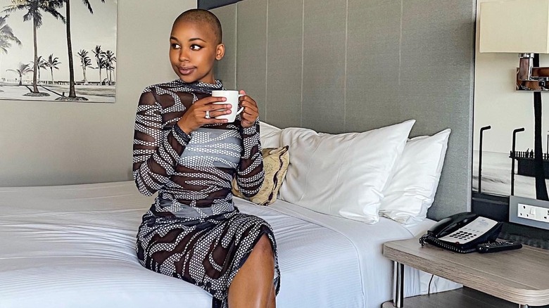 Woman wears patterned mesh dress